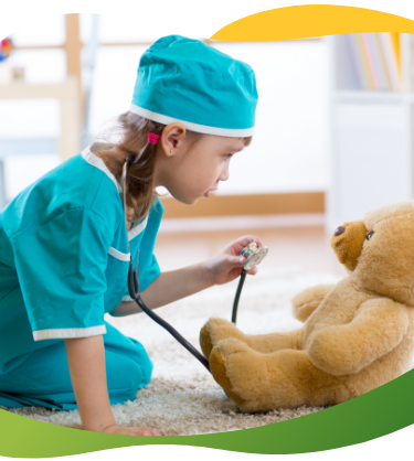 A child dressed up as a nurse and examining her teddy bear