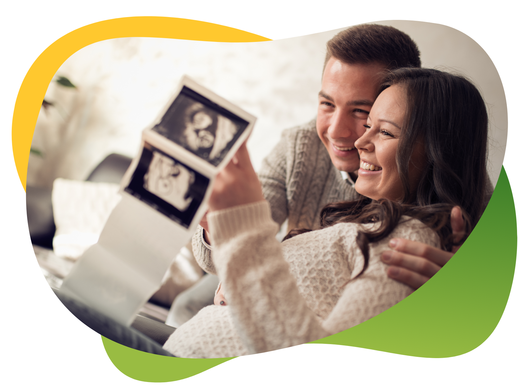 Parents-to be look at ultrasound images of the baby